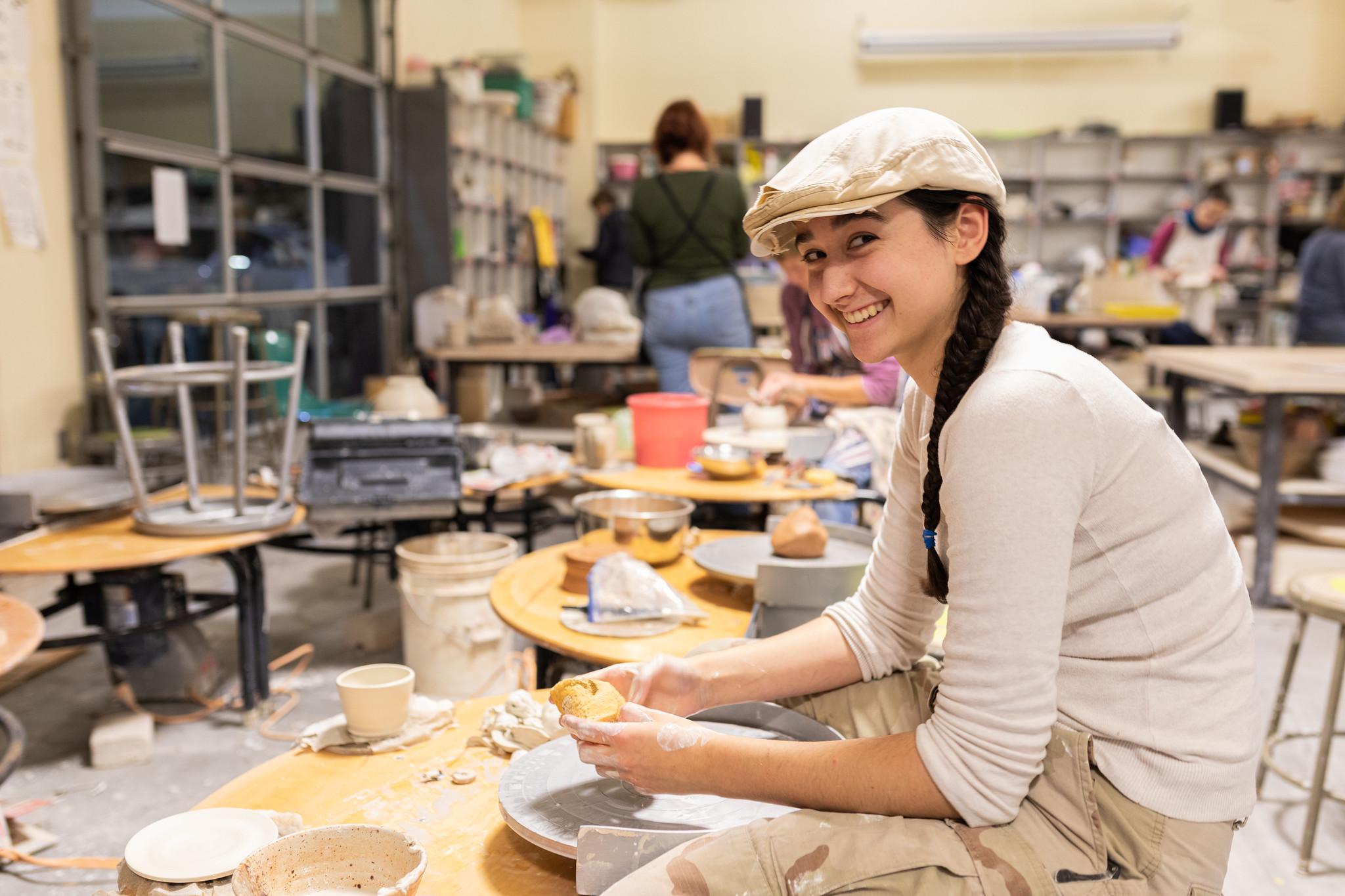 Photo of student using pottery wheel